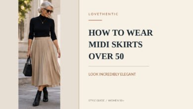 Elegant woman over 50 wearing a pleated beige midi skirt with a black sweater and ankle boots